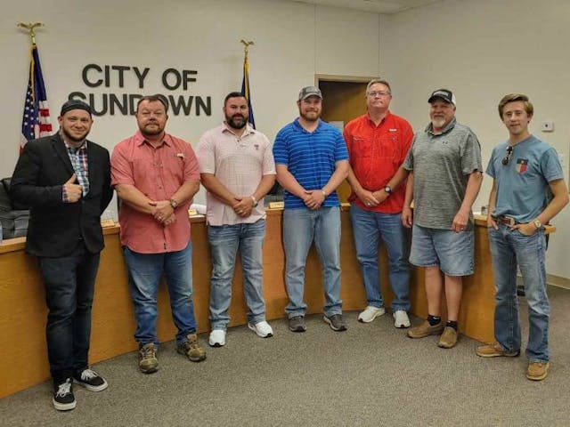Right To Life of East Texas Director Mark Lee Dickson and Sundown Resident Matt Nichols take a picture with Mayor Jonathan Strickland and the Sundown City Council between them. (Photo: Mark Lee Dickson)