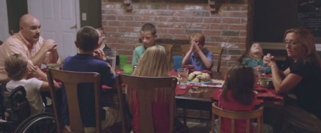 The Martin family gathers for a meal (screenshot via Human Coalition video) adopt, adoption, special needs