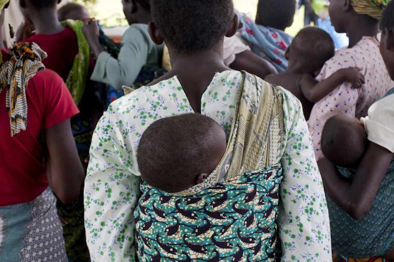 Mothers carrying children and waiting at rural health clinic