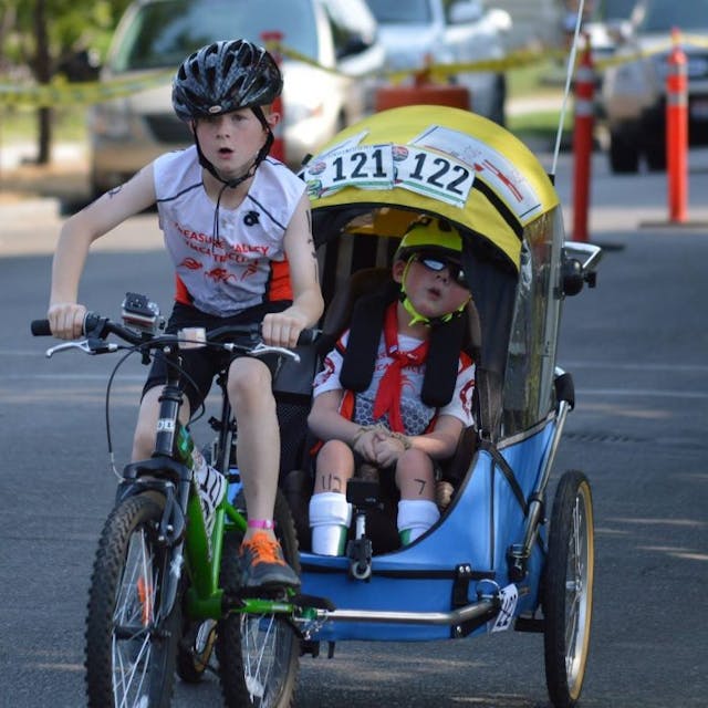 Noah and Lucas Aldrich compete on bike in a triathlon. Noah and Lucas Aldrich compete on bike in a triathlon