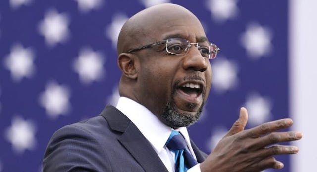 ATLANTA, GA – DECEMBER 15: U.S. Democratic Senate candidate Raphael Warnock delivers remarks during a campaign rally with U.S. President-elect Joe Biden at Pullman Yard on December 15, 2020 in Atlanta, Georgia. (Photo by Drew Angerer/Getty Images) Warnock