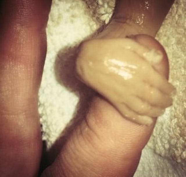 Branson's hand wrapped across his mother's finger - via Facebook.