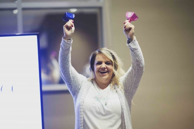 A volunteer celebrates Love Boxes.