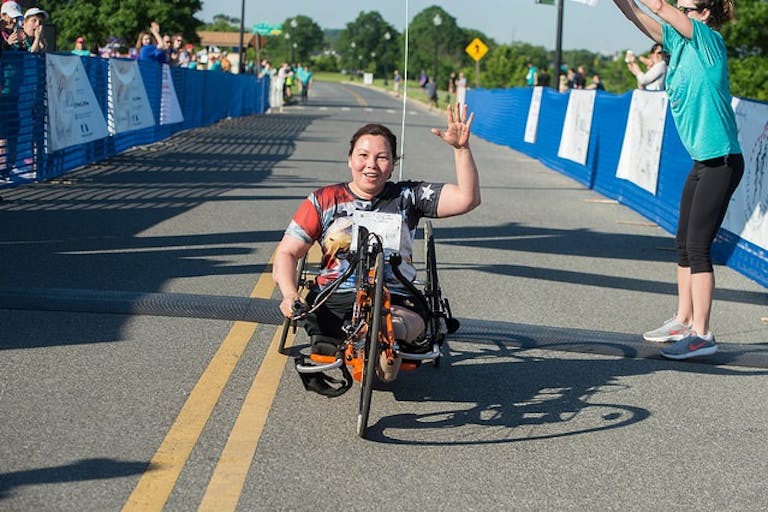 Sen. Duckworth, who supports unlimited abortions for women, participates in a race using an adapted bike.