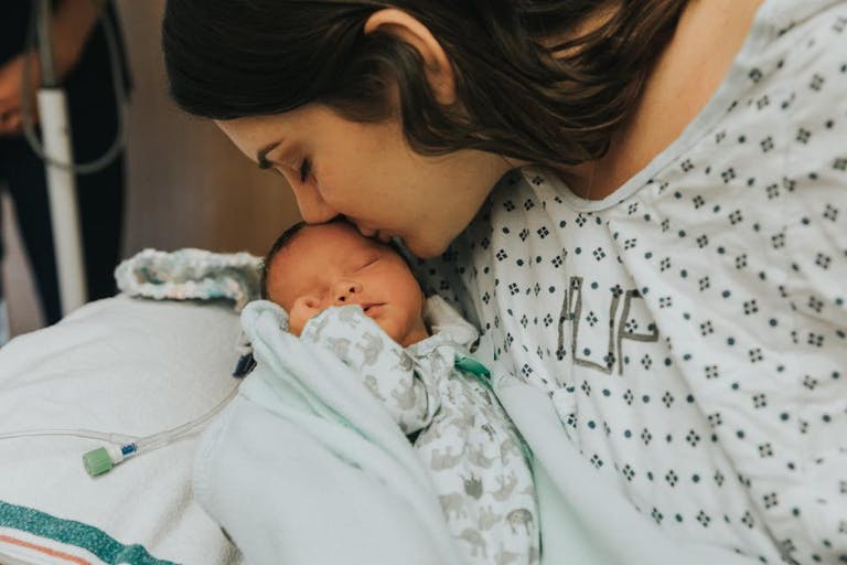 Dana Scatton kisses her baby girl who was born by emergency C-section after Dana was diagnosed with a brain tumor.