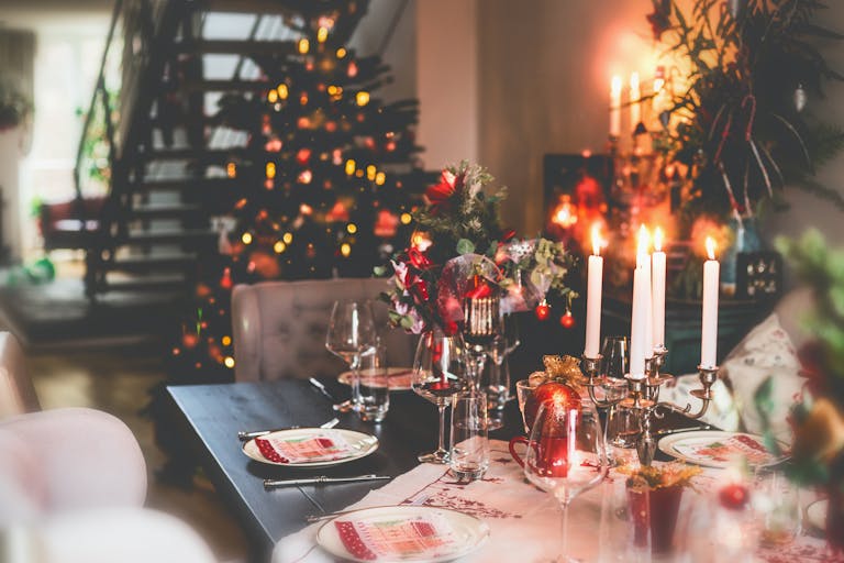 Christmas dinner table at festive cozy room background with Christmas tree