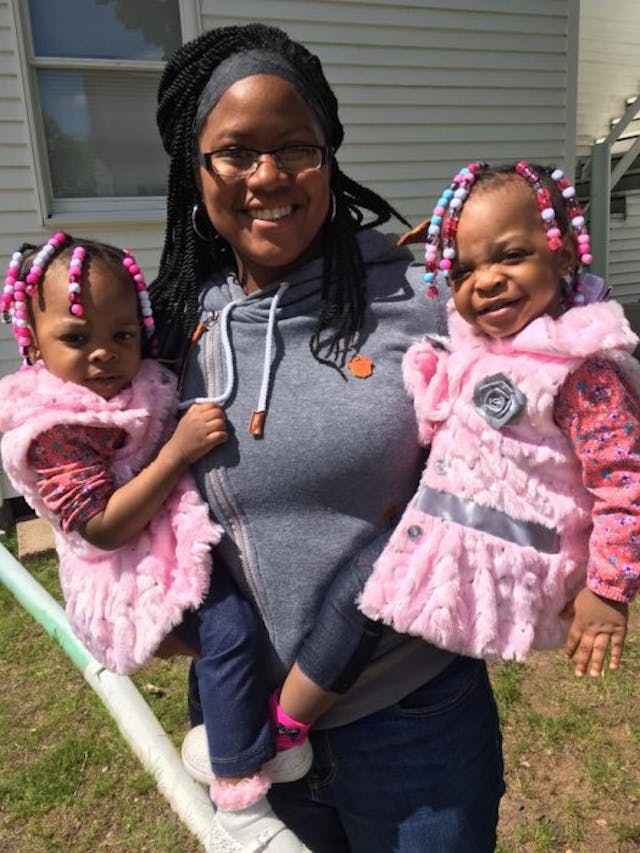 One of our volunteers holding our client’s twins How we responded when NARAL activists came to protest our pregnancy center image