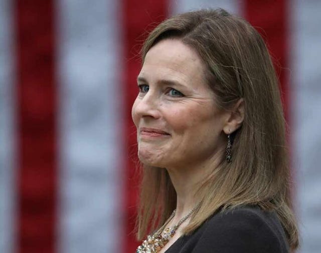 WASHINGTON, DC – SEPTEMBER 26: Seventh U.S. Circuit Court Judge Amy Coney Barrett looks on while being introduced by U.S. President Donald Trump as his nominee to the Supreme Court during an event in the Rose Garden at the White House September 26, 2020 in Washington, DC. With 38 days until the election, Trump tapped Barrett to be his third Supreme Court nominee in just four years and to replace the late Associate Justice Ruth Bader Ginsburg, who will be buried at Arlington National Cemetery on Tuesday. (Photo by Chip Somodevilla/Getty Images) barrett
