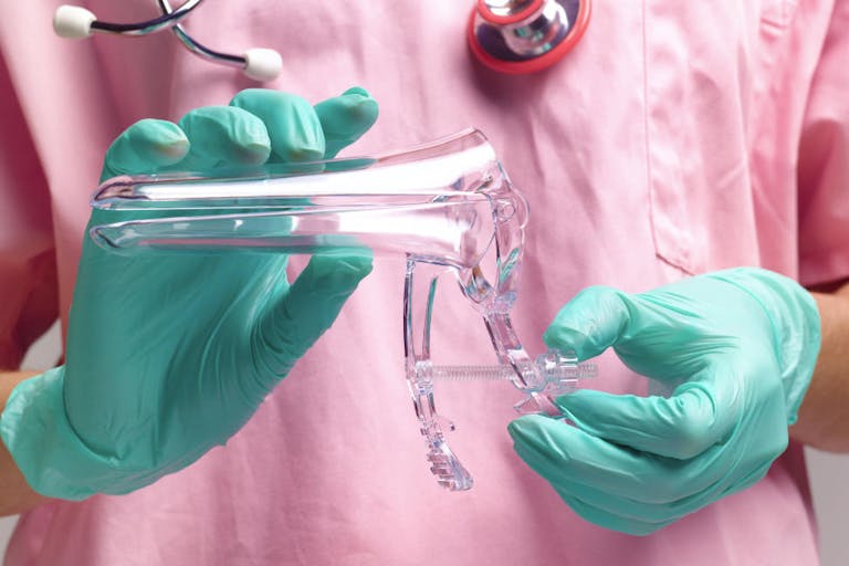 Gynaecologist holding vaginal speculum