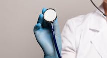 Close-up of female doctor using stethoscope, focus on stethoscope