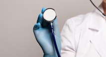 Close-up of female doctor using stethoscope, focus on stethoscope