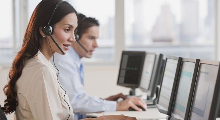 Hispanic businesswoman working on computer