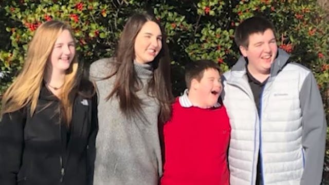 Jake and his new siblings. Screenshot CBS12 Teacher adopts student with Down syndrome after mom dies of cancer image