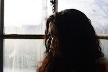 sad woman looking out window
