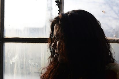 sad woman looking out window