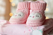 Photo: Pexels.com/Pixabay Photo shows pink baby booties on top of a pink baby blanket