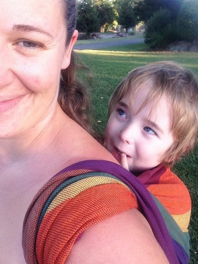 Kyle looks lovingly up at his mother as she carries him on her back. Kyle was born with spina bifida after his parents refused abortion. Photo courtesy of the Wells family chose life