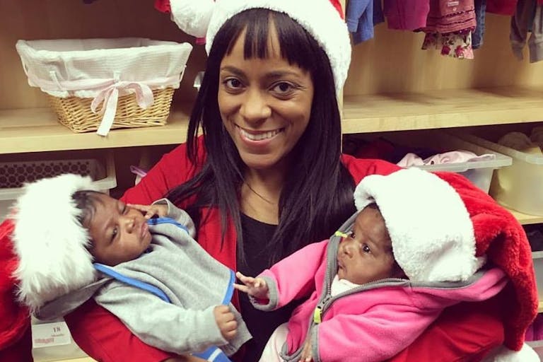A pregnancy resource center employee, with with her client's twins. The babies were born close to Christmas after their mother changed her mind about abortion.