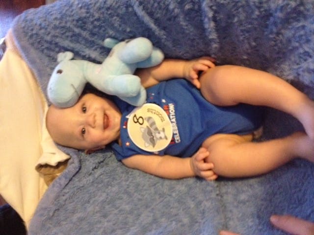 Nathaniel this summer with the same blue giraffe and a big smile to go with it.