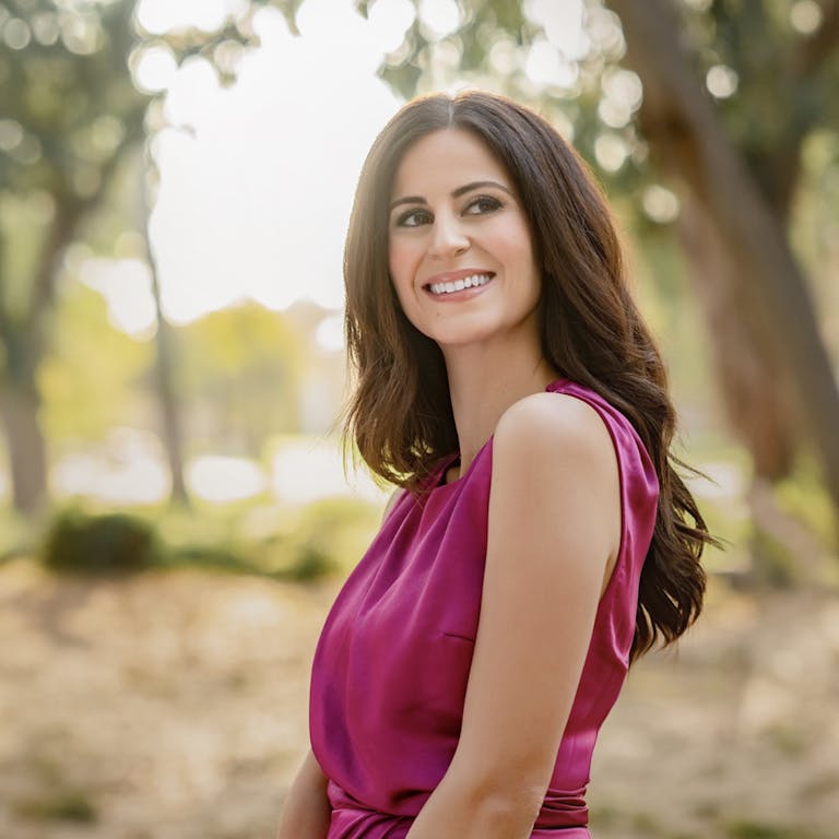 Woman standing outside in a pink dress