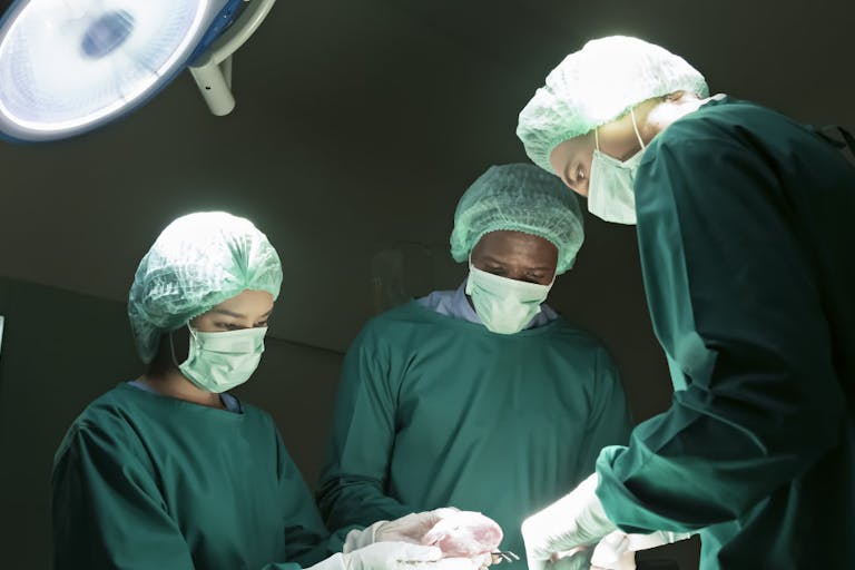Surgeons are performing heart transplant operation for a serious patient.