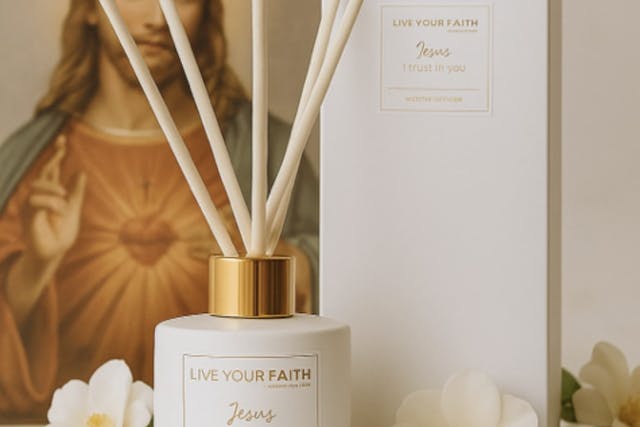 A photo of jesus and a jar of perfume