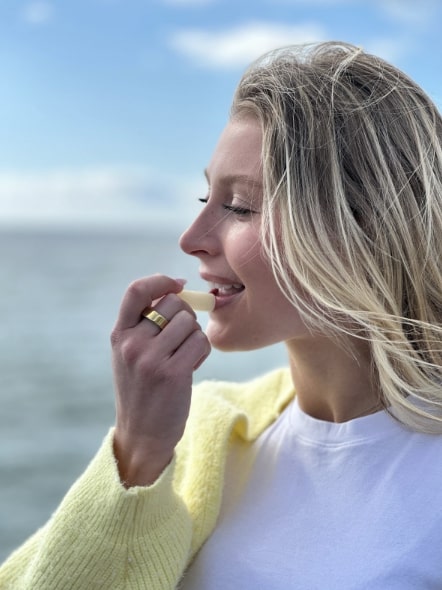 A woman putting on chapstick
