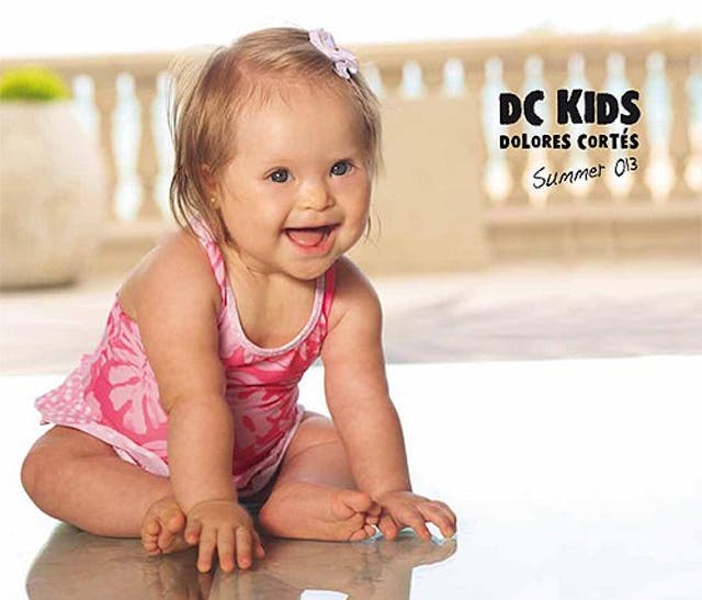 Baby with Down syndrome becomes model for “prestigious fashion designer” image