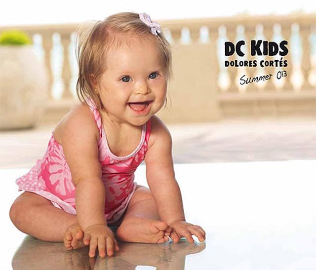 Baby with Down syndrome becomes model for “prestigious fashion designer” image
