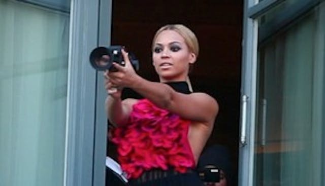 Beyoncé holds a camera. Image via HBO. Beyonce