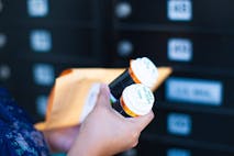 Photo: timnewman/Getty Images Woman Receiving Medicine by Mail