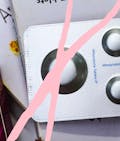 The abortion pill and packing with a pink 'X' drawn over it