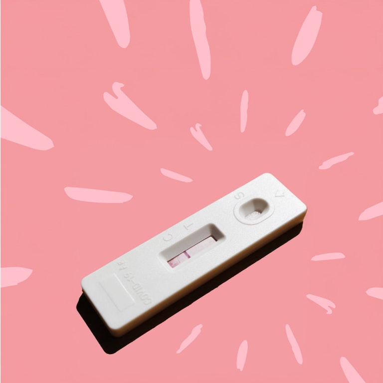A pregnancy test on a pink background