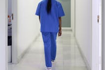 Photo: Tempura/Getty Images A nurse walks down the hospital corridor first thing in the morning.