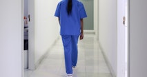 A nurse walks down the hospital corridor first thing in the morning.