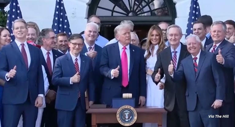 Trump gives a thumbs up after signing reconciliation bill surrounded by his wife Melania and federal legislators. The bill defunds Planned Parenthood for one year.