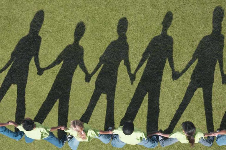 Shadows of children holding hands in a line Shadows of children holding hands in a line