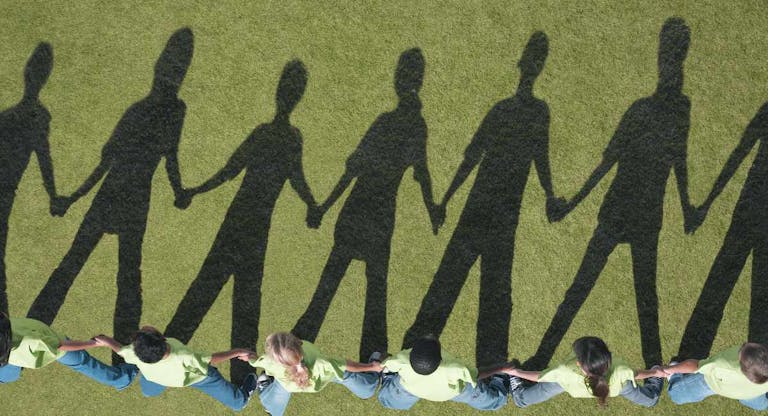 Shadows of children holding hands in a line