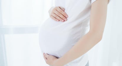 Pregnant woman holding her belly
