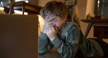 Young kid looking movies on the laptop