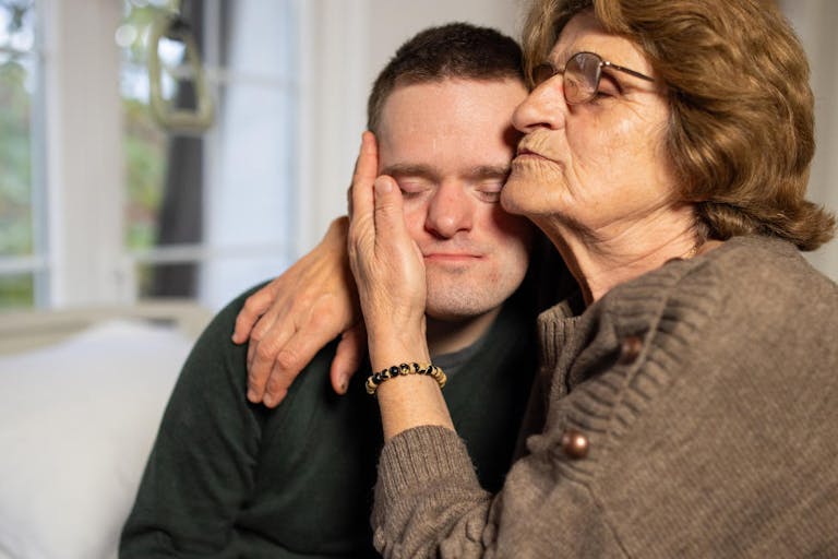 Mother visiting her son with Down syndrome in a hospital room. A heartfelt representation of family care, resilience, and the healing power of connection. Mother Comforts Special Needs Son