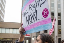 PORTLAND, ME - MARCH 1: Lindsay Ware carries a sign supporting transgender rights while walking with a group from Planned Parenthood on Congress Street before a rally at city hall. (Staff photo by Derek Davis/Portland Portland Press Herald via Getty Images) Rally for transgender rights