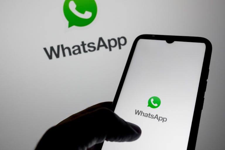 The WhatsApp logo appears on a smartphone screen and as a background on a computer screen in this photo illustration in Athens, Greece, on August 6, 2025. WhatsApp takes down 6.8 million accounts linked to scammers targeting people around the world in the first half of this year, its parent company Meta says. (Photo by Nikolas Kokovlis/NurPhoto via Getty Images) WhatsApp Deletes Over 6.8m Accounts Linked To Scams, Meta Says