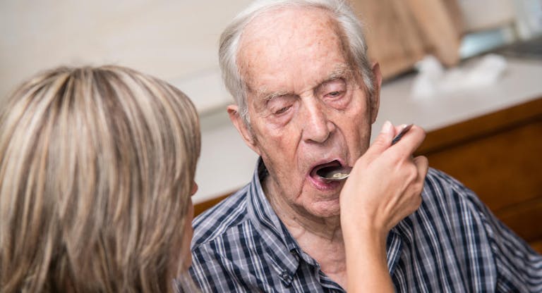 Seniors Having Lunch In Elderly Day Care Center
