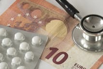 flat lay heap of medicines Assorted pharmaceutical medicine pills, tablets, stethoscope and money against white background