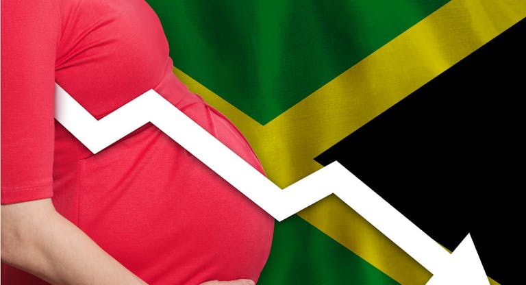 Jamaican pregnant woman on flag of Jamaica background. Falling fertility rate