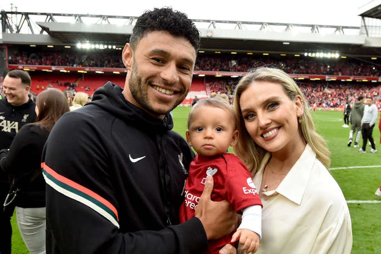 LIVERPOOL, ENGLAND - MAY 22: (THE SUN OUT, THE SUN ON SUNDAY OUT) Alex Oxlade-Chamberlain of Liverpool posing for a photograph with Perrie Edwards and their baby boy at the end of the Premier League match between Liverpool and Wolverhampton Wanderers at Anfield on May 22, 2022 in Liverpool, England. (Photo by Andrew Powell/Liverpool FC via Getty Images) Liverpool v Wolverhampton Wanderers – Premier League