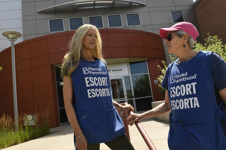 Photo by Helen H. Richardson/MediaNews Group/The Denver Post via Getty Images DENVER, CO - JULY 18: Volunteer escorts wait to assist incoming patients outside of the Planned Parenthood on July 18, 2019 in Denver, Colorado. With recent restrictions to abortions in other states Planned Parenthood has seen an increase in women coming to Colorado from out of state. Planned Parenthood's Colorado locations served women from 34 states last year and one in 10 abortions was for someone who crossed state lines.