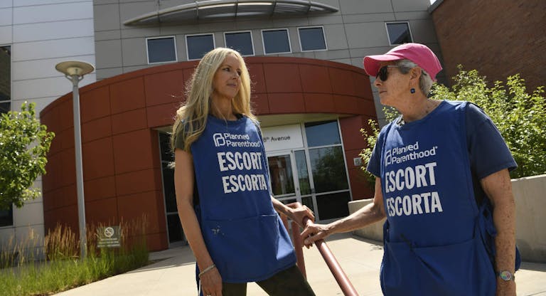 DENVER, CO - JULY 18: Volunteer escorts wait to assist incoming patients outside of the Planned Parenthood on July 18, 2019 in Denver, Colorado. With recent restrictions to abortions in other states Planned Parenthood has seen an increase in women coming to Colorado from out of state. Planned Parenthood's Colorado locations served women from 34 states last year and one in 10 abortions was for someone who crossed state lines.