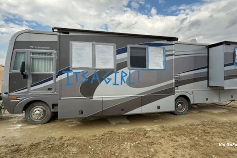 Photo via GoFundMe An RV parked at Burning Man, with the words, "It's a Girl!"